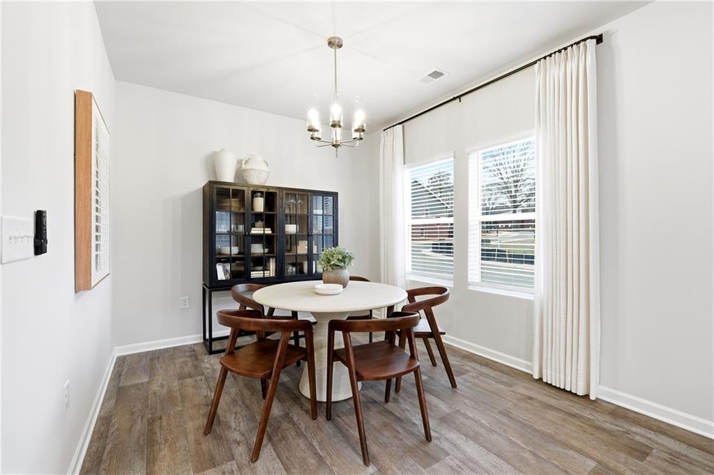 3227 Winding Waters Way, Unit 36 Powder Springs, GA 30127 - Photo 12 of 30 a view of a dining room with furniture window and wooden floor