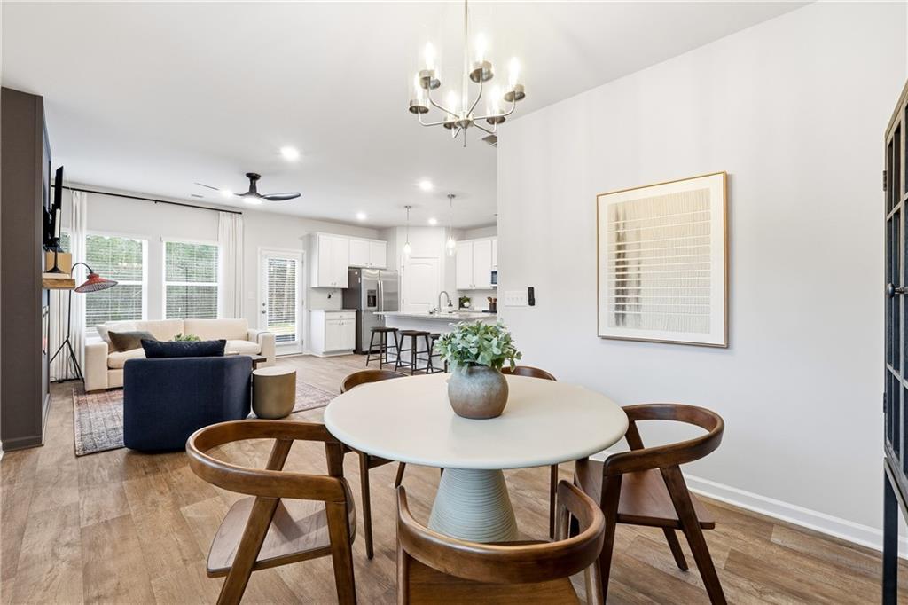 3227 Winding Waters Way, Unit 36 Powder Springs, GA 30127 - Photo 13 of 30 a dining room with furniture a window and wooden floor