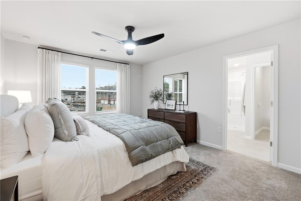 3227 Winding Waters Way, Unit 36 Powder Springs, GA 30127 - Photo 14 of 30 a bedroom with a large bed and a large window