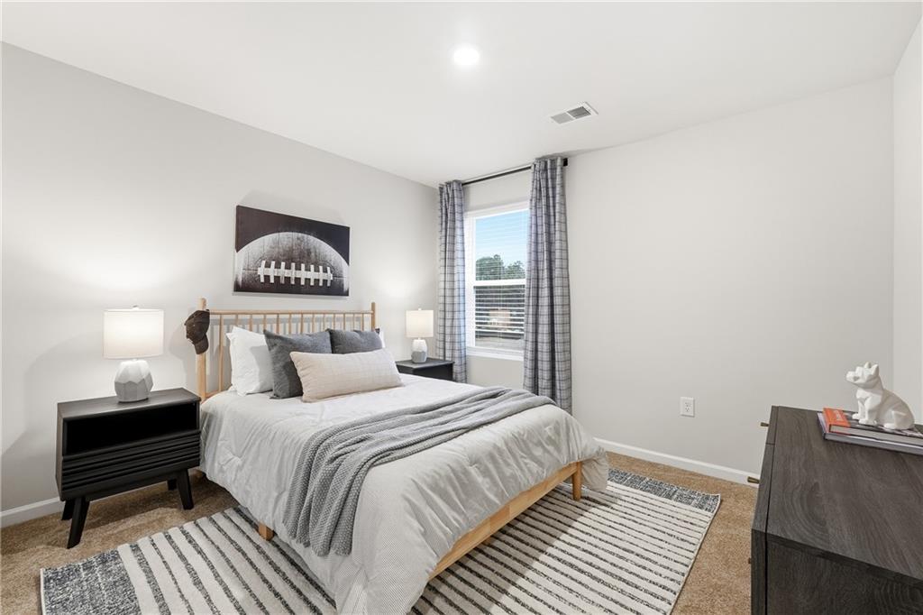 3227 Winding Waters Way, Unit 36 Powder Springs, GA 30127 - Photo 20 of 30 a bedroom with a bed and a night stand