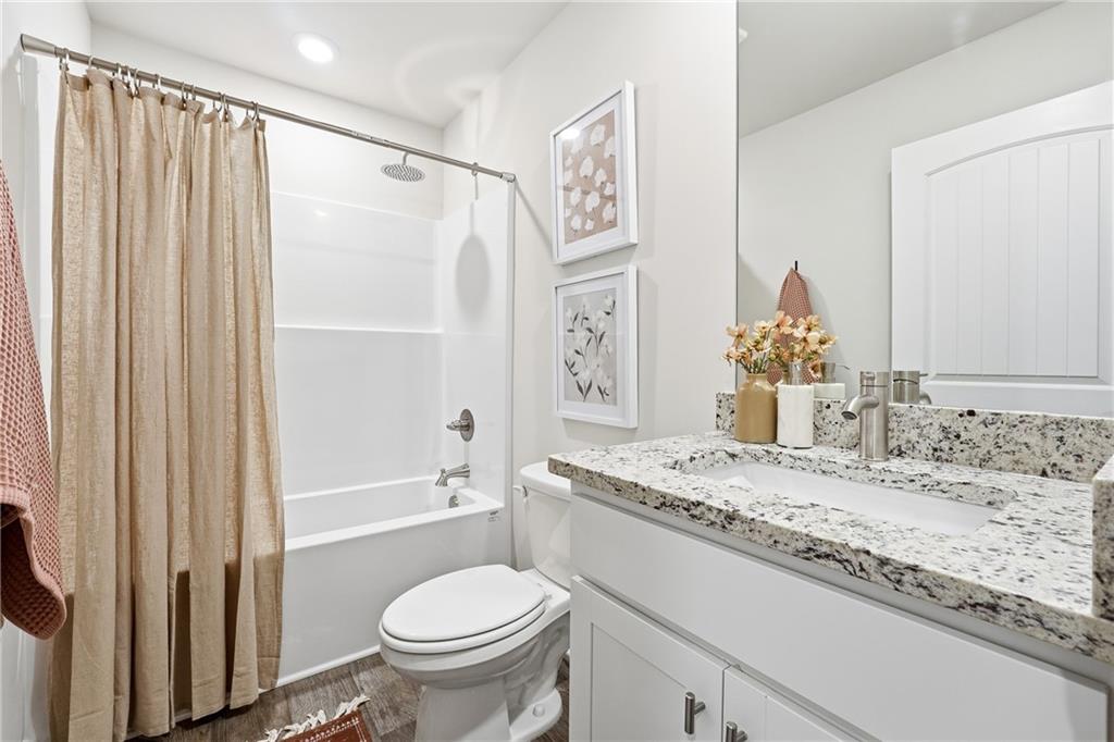 3227 Winding Waters Way, Unit 36 Powder Springs, GA 30127 - Photo 21 of 30 a bathroom with a granite countertop sink toilet and shower