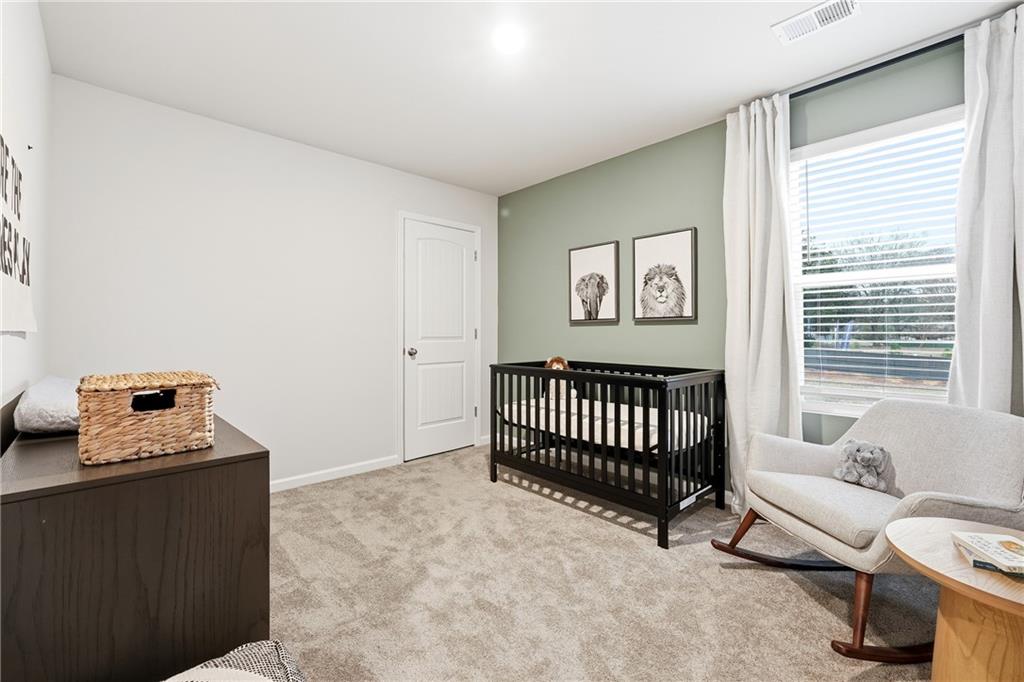 3227 Winding Waters Way, Unit 36 Powder Springs, GA 30127 - Photo 22 of 30 a bedroom with furniture and a window