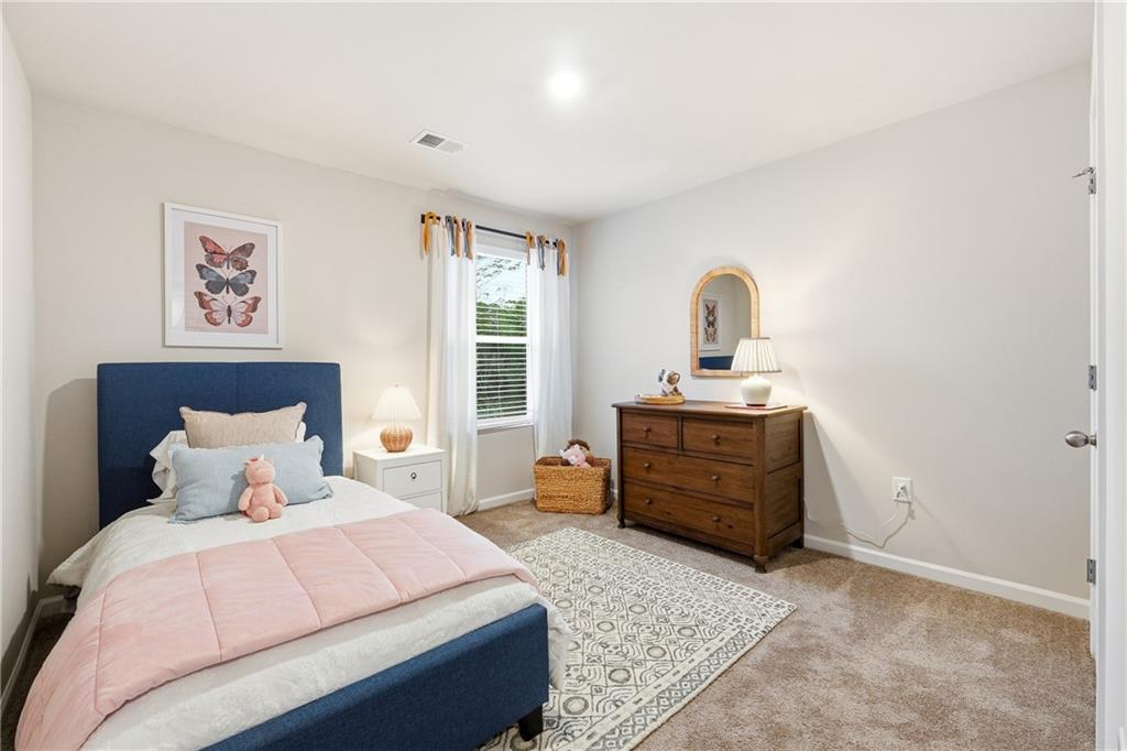 3227 Winding Waters Way, Unit 36 Powder Springs, GA 30127 - Photo 23 of 30 a bedroom with a bed and a dresser