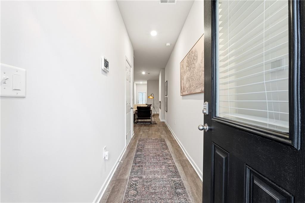 3227 Winding Waters Way, Unit 36 Powder Springs, GA 30127 - Photo 28 of 30 a view of a hallway with wooden floor and staircase