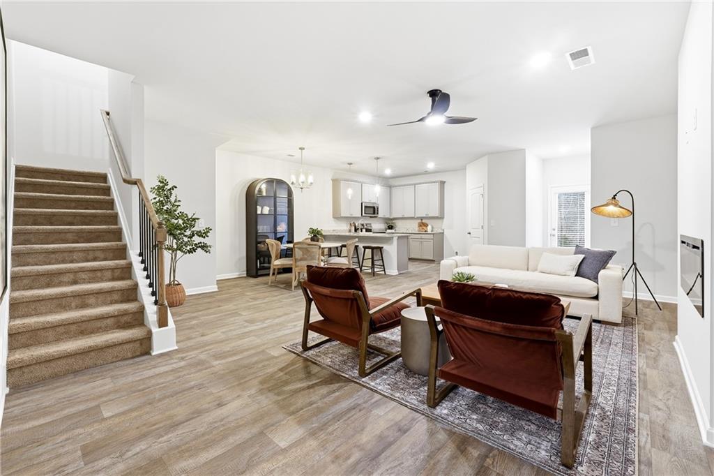 3227 Winding Waters Way, Unit 36 Powder Springs, GA 30127 - Photo 29 of 30 a living room with furniture and wooden floor