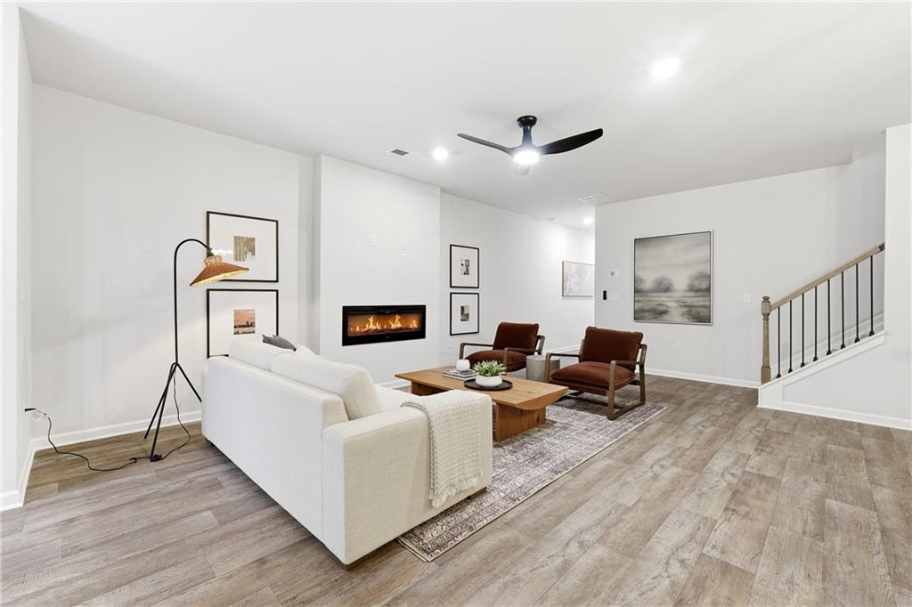3227 Winding Waters Way, Unit 36 Powder Springs, GA 30127 - Photo 30 of 30 a living room with furniture and a wooden floor