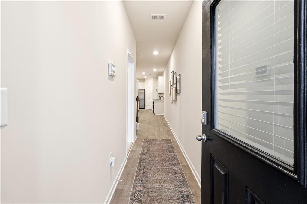 3227 Winding Waters Way, Unit 36 Powder Springs, GA 30127 - Photo 4 of 30 a view of a hallway with wooden floor and staircase