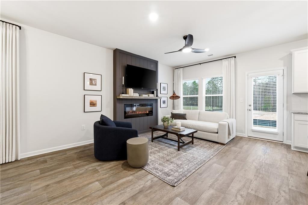 3227 Winding Waters Way, Unit 36 Powder Springs, GA 30127 - Photo 5 of 30 a living room with furniture and a flat screen tv