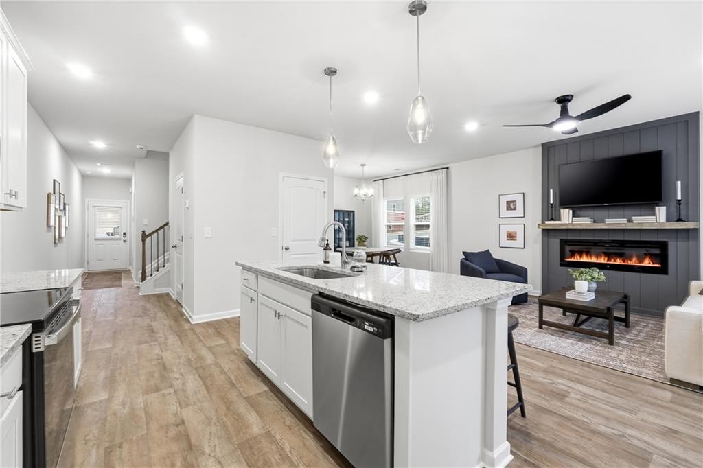 3227 Winding Waters Way, Unit 36 Powder Springs, GA 30127 - Photo 9 of 30 a kitchen with counter top space a sink stainless steel appliances and cabinets