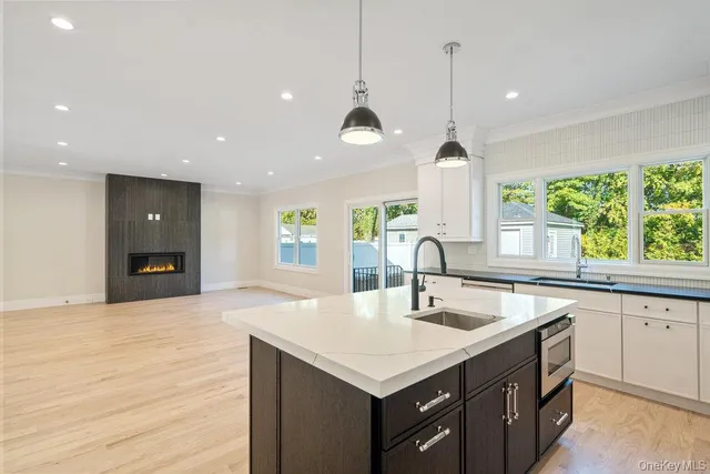 a view of a house with a yard and a large tree