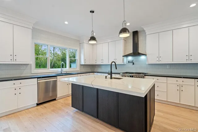 a view of empty room with wooden floor and fireplace