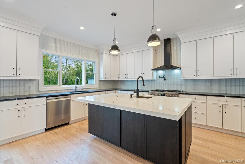 47 Netz Place Albertson, NY 11507 - Photo 15 of 41 Kitchen with decorative backsplash, wall chimney range hood, dishwasher, pendant lighting, and recessed lighting