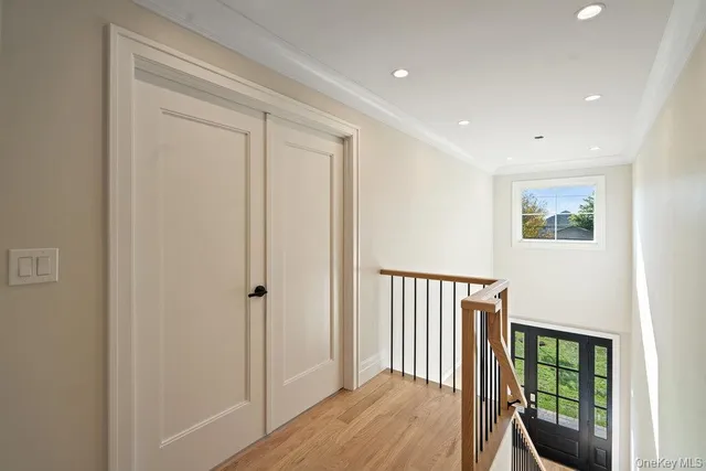 a kitchen with stainless steel appliances granite countertop a sink a stove a refrigerator and a oven with wooden floor