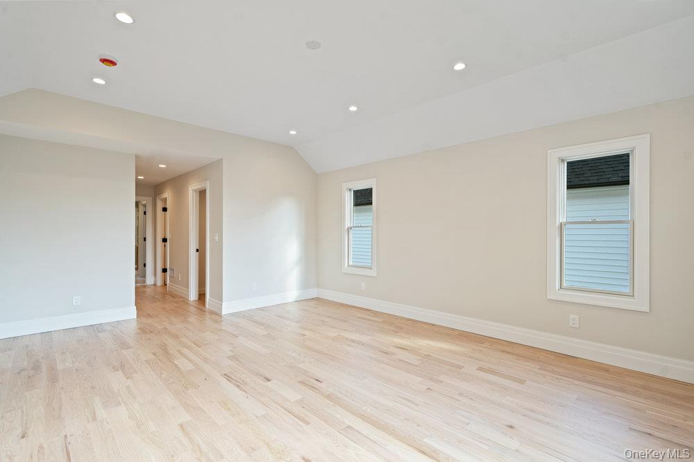 47 Netz Place Albertson, NY 11507 - Photo 22 of 41 Spare room featuring recessed lighting, light wood finished floors, and lofted ceiling