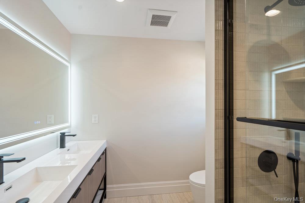 47 Netz Place Albertson, NY 11507 - Photo 27 of 41 Bathroom with double vanity and a tile shower