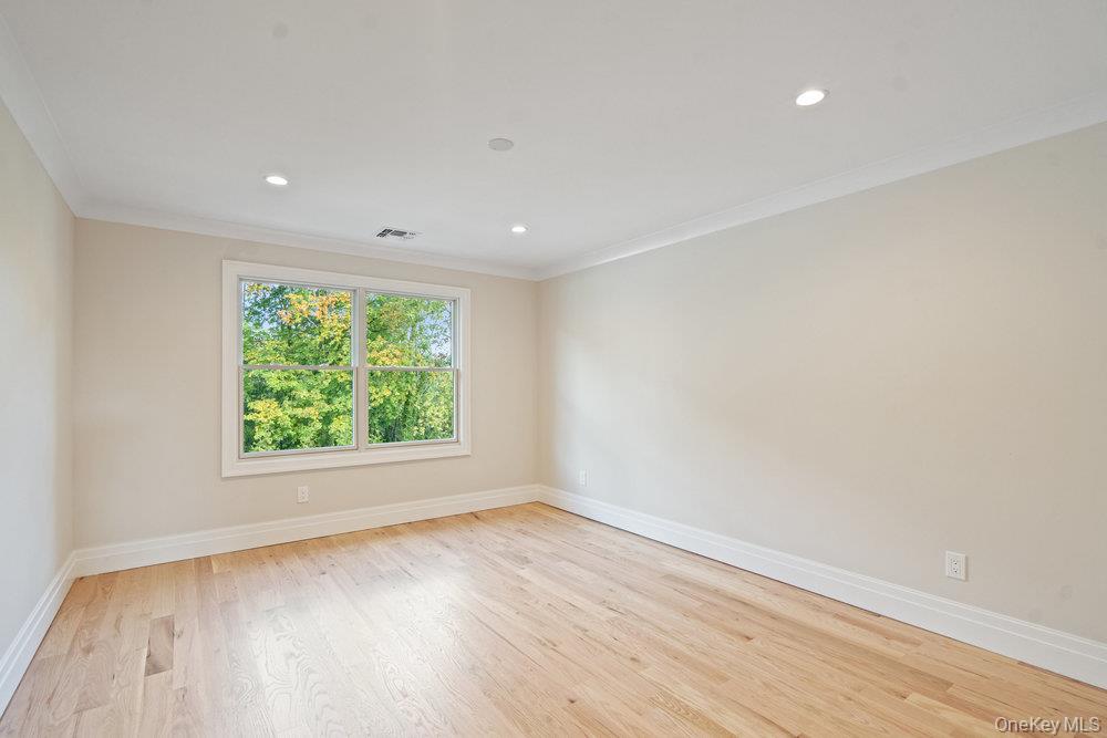 47 Netz Place Albertson, NY 11507 - Photo 28 of 41 Spare room with light wood-style floors, ornamental molding, and recessed lighting