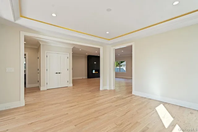 a view of a hallway with wooden floor and closet