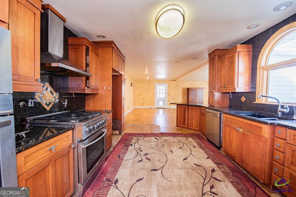 1441 Zenith Mill Road Roberta, GA 31078 - Photo 35 of 80 a kitchen with stainless steel appliances granite countertop a stove a sink and a microwave