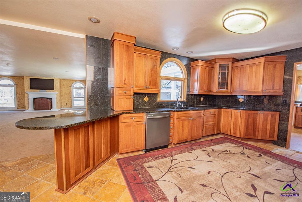 1441 Zenith Mill Road Roberta, GA 31078 - Photo 37 of 80 a kitchen with stainless steel appliances granite countertop a stove a sink and a microwave