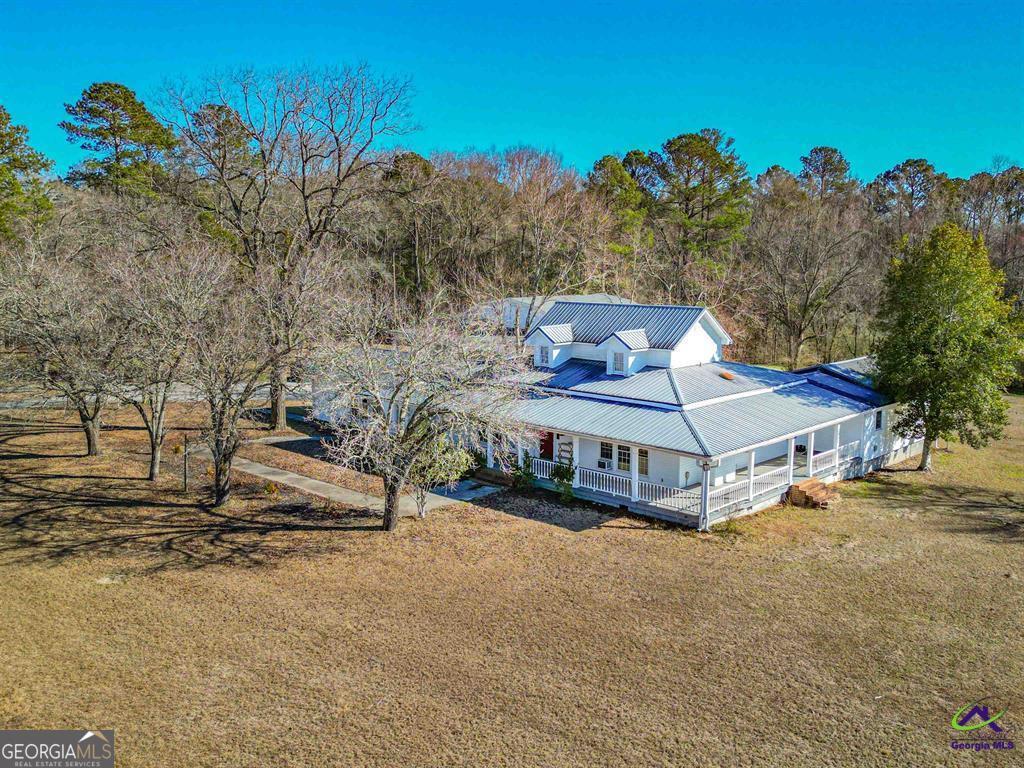 1441 Zenith Mill Road Roberta, GA 31078 - Photo 4 of 80 a view of a white house with a big yard and large trees