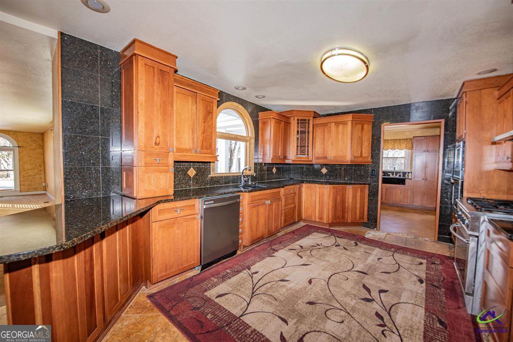 1441 Zenith Mill Road Roberta, GA 31078 - Photo 42 of 80 a kitchen with stainless steel appliances granite countertop a stove a sink and a refrigerator