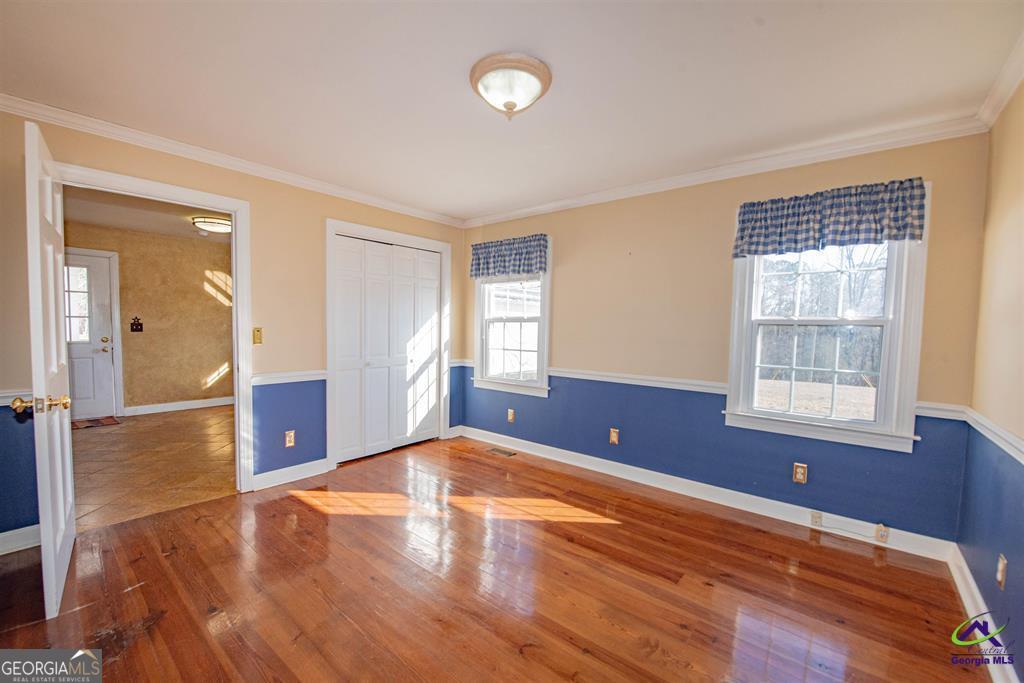 1441 Zenith Mill Road Roberta, GA 31078 - Photo 45 of 80 an empty room with wooden floor and windows