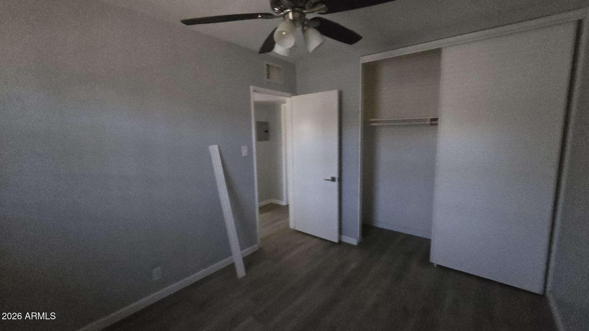 834 West Osborn Road Phoenix, AZ 85013 - Photo 23 of 45 an empty room with wooden floor and fan