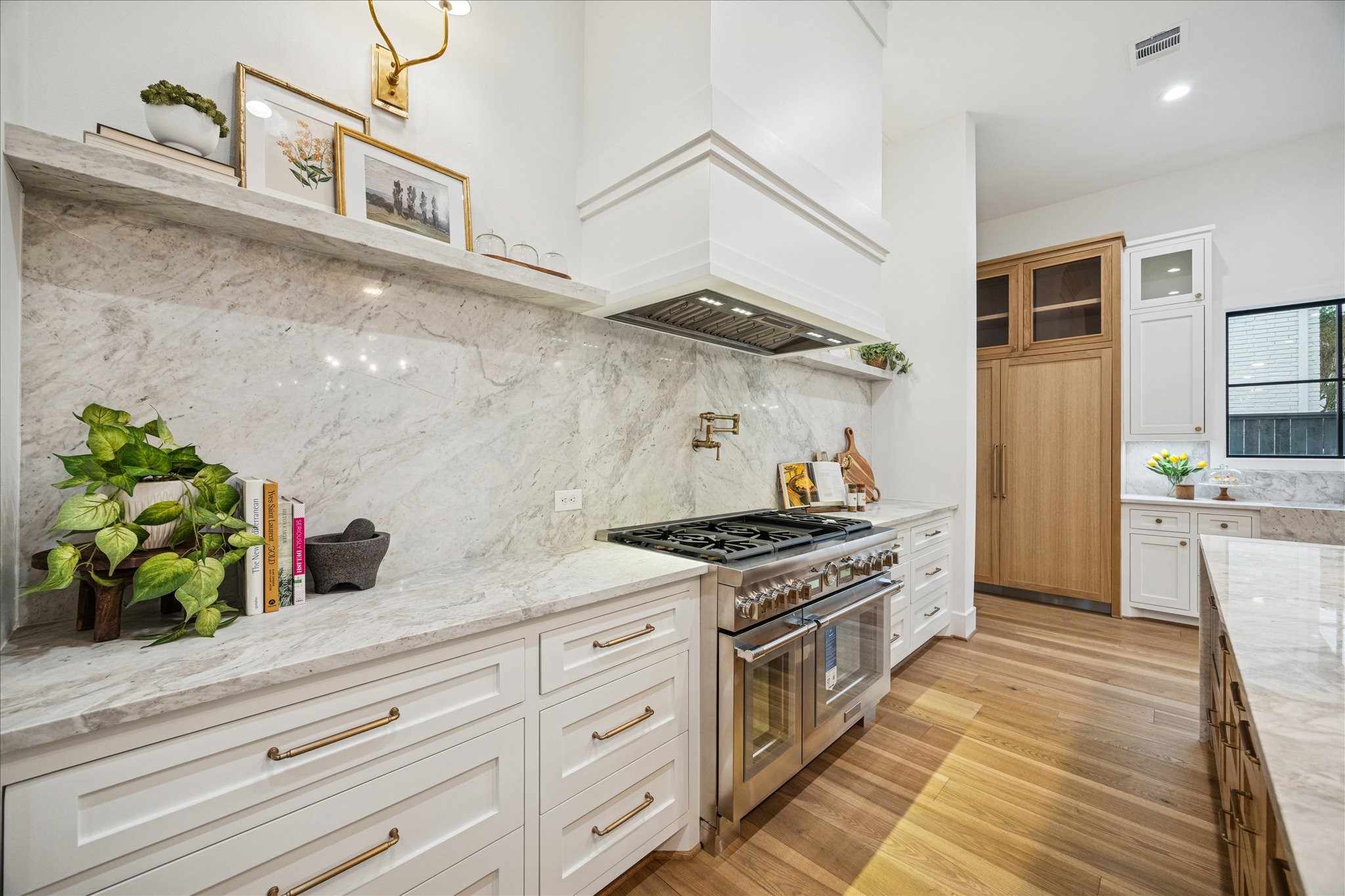 830 Azalea Street Houston, TX 77018 - Photo 13 of 50 For those who love to cook or entertain, the Thermador 6-burner gas range offers the ideal balance of power and finesse. Its generous cooking surface transitions seamlessly from high-heat searing to delicate simmering, all set against a backdrop of custom cabinetry and natural stone.