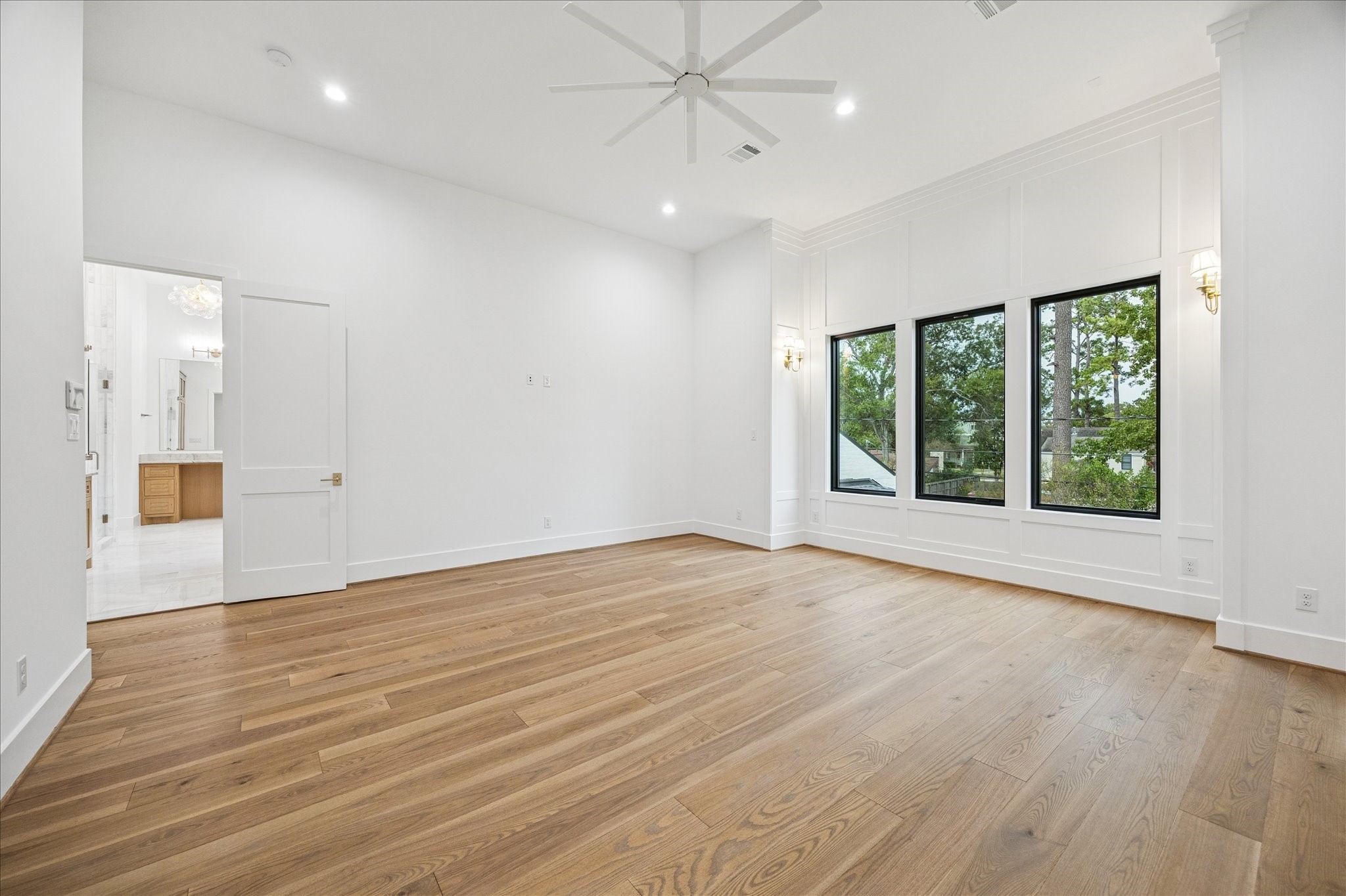830 Azalea Street Houston, TX 77018 - Photo 19 of 50 Natural light pours through oversized windows, highlighting a calm, elevated space. Vaulted ceilings—one of Arch Angelo’s signatures—enhance scale and privacy.