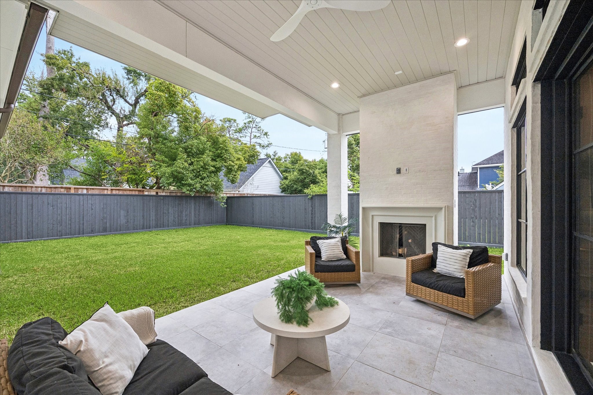 830 Azalea Street Houston, TX 77018 - Photo 32 of 50 A clean-lined fireplace, high ceilings, and generous covered space create a year-round outdoor lounge. Spray foam roofline enhances temperature control even in peak summer.