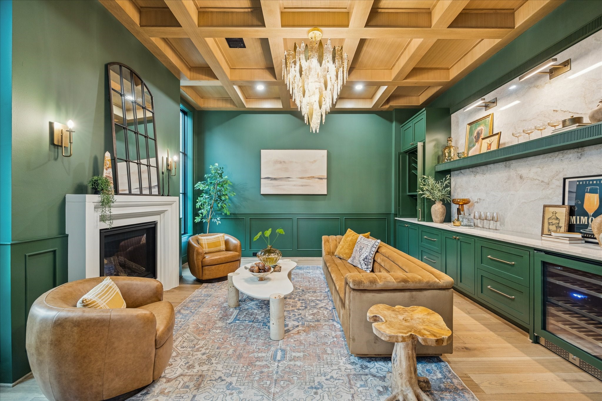 830 Azalea Street Houston, TX 77018 - Photo 4 of 50 Rich green millwork, a coffered ceiling, and warm textures shape a refined yet welcoming study, complete with custom built-ins, Emtek hardware, and a cozy fireplace. An integrated Avallon beverage center enhances flexibility, making the room equally suited for an office, reading lounge, or listening room. The first floor features impressive 12 ft ceilings for an even more expansive feel.