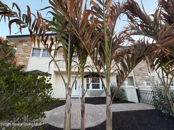 a view of a house with a tree