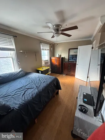 a bedroom with a bed mirror and window