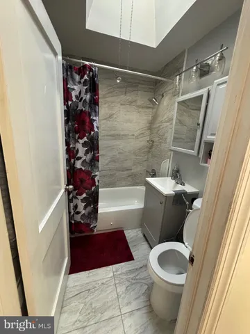 a bathroom with a toilet and shower