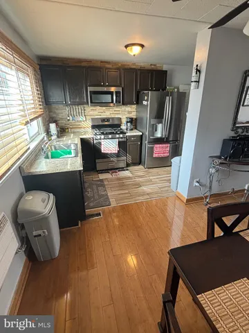 a kitchen with microwave a stove and furniture