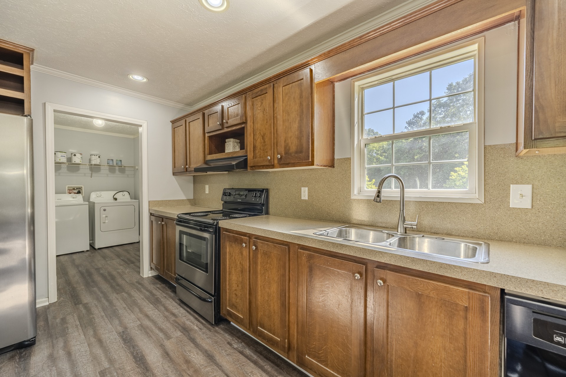 1125 Clifft Road Bolivar, TN 38008 - Photo 16 of 78 a kitchen with stainless steel appliances granite countertop a sink stove and refrigerator
