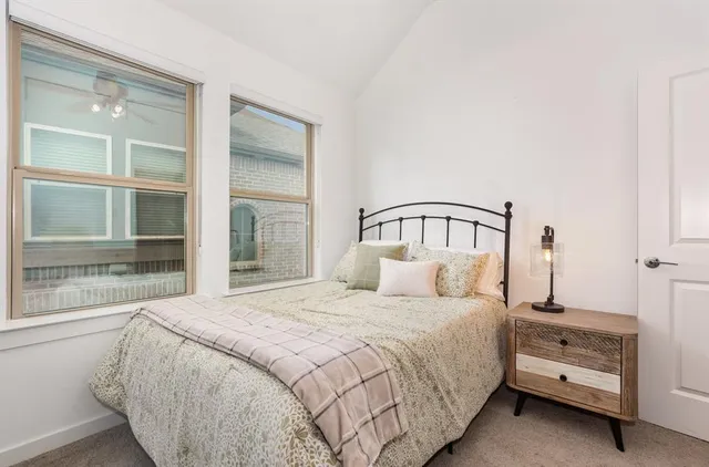 a bedroom with a bed and large window