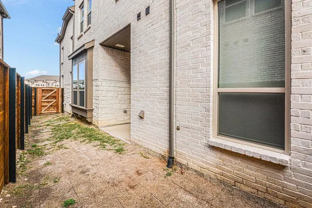 a view of a house with a wooden fence