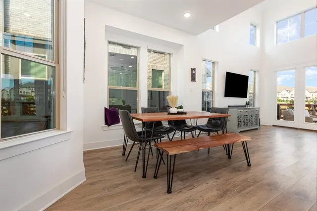 a dining room with furniture and wooden floor