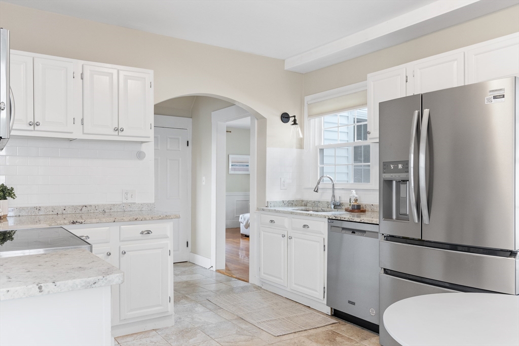 170 West Street, Unit 170 Needham, MA 02494 - Photo 13 of 32 a kitchen with white cabinets and stainless steel appliances