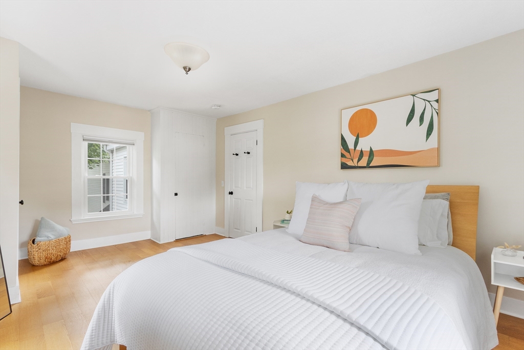 170 West Street, Unit 170 Needham, MA 02494 - Photo 18 of 32 a bedroom with a bed and wooden floor