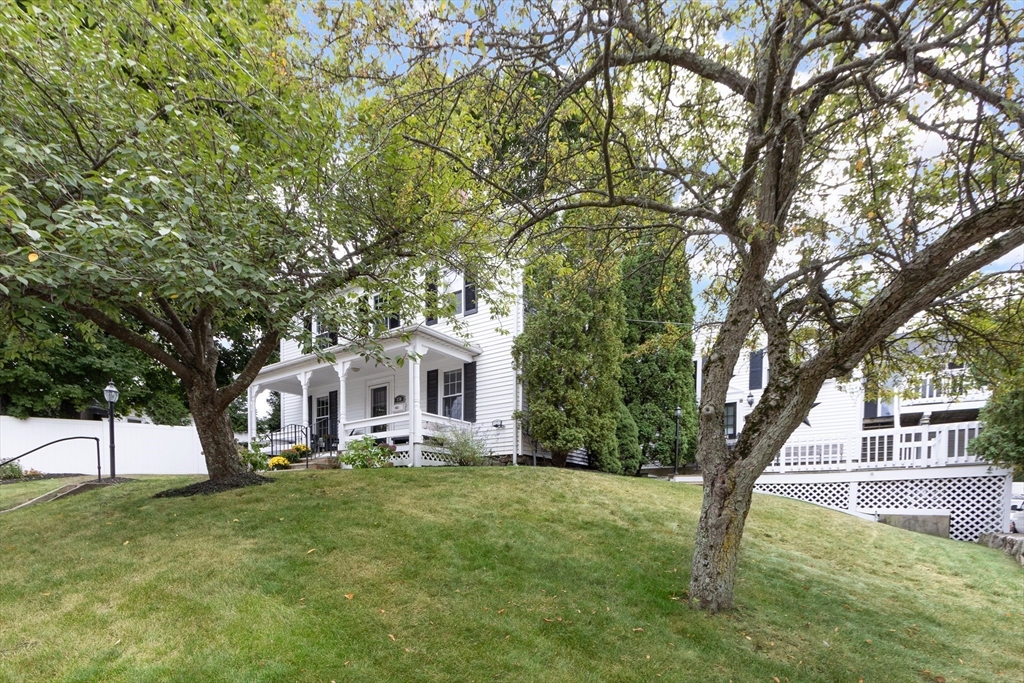 170 West Street, Unit 170 Needham, MA 02494 - Photo 28 of 32 a front view of a house with a yard and trees