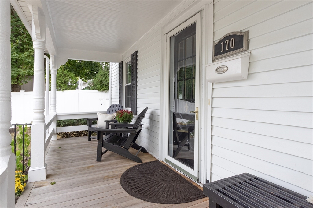170 West Street, Unit 170 Needham, MA 02494 - Photo 4 of 32 a living room with furniture and a gate
