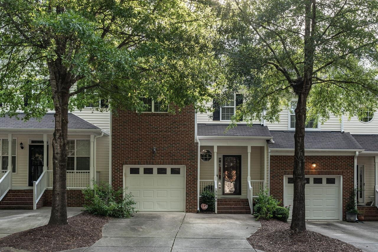 front view of a house with a tree