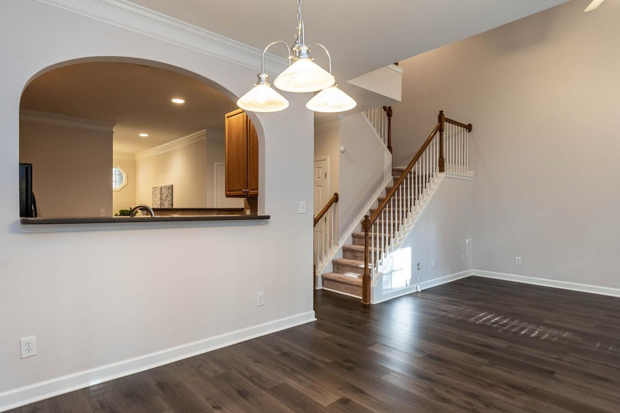 5948 Kohler Lane Raleigh, NC 27616 - Photo 12 of 32 a view of a living room with wooden floor and staircase