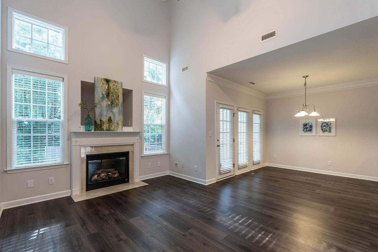 5948 Kohler Lane Raleigh, NC 27616 - Photo 15 of 32 a view of an empty room with wooden floor fireplace and a window