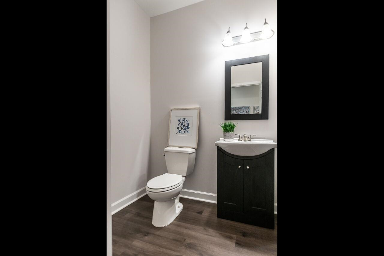 5948 Kohler Lane Raleigh, NC 27616 - Photo 17 of 32 a bathroom with a toilet a sink and mirror