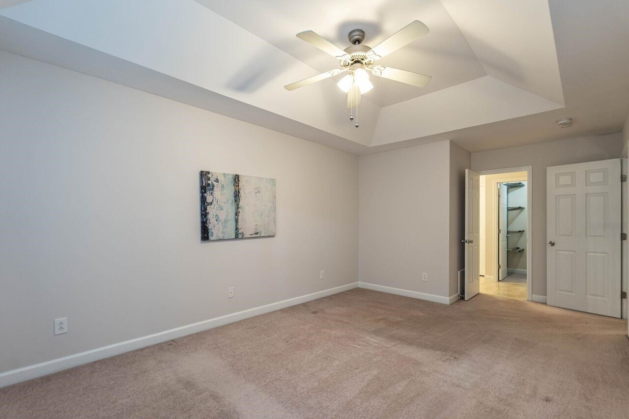 5948 Kohler Lane Raleigh, NC 27616 - Photo 20 of 32 an empty room with a ceiling fan and window