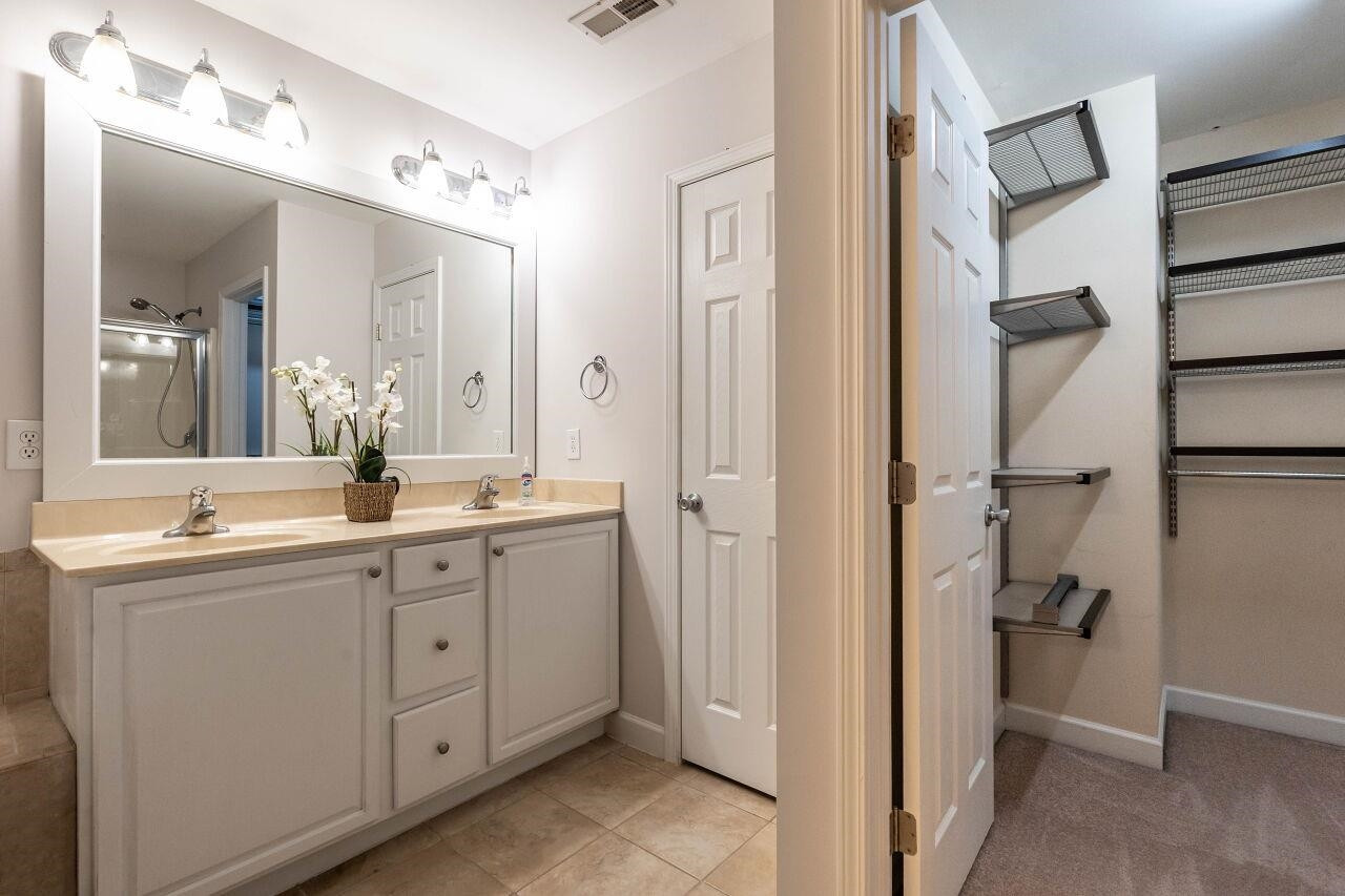 5948 Kohler Lane Raleigh, NC 27616 - Photo 21 of 32 a bathroom with a double vanity sink and mirror