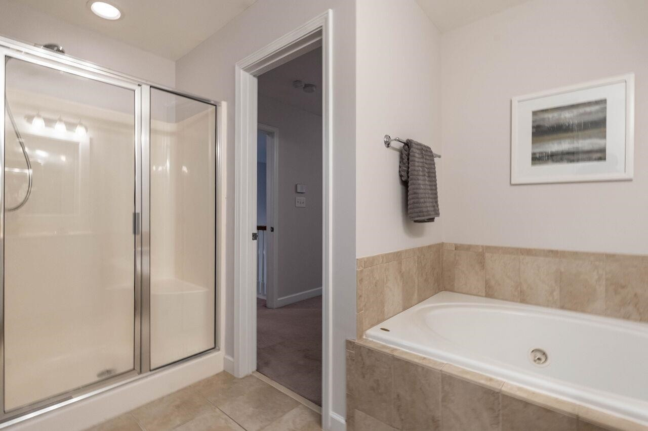 5948 Kohler Lane Raleigh, NC 27616 - Photo 23 of 32 a bathroom with a tub and shower
